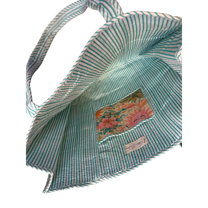 An inside view of the bag with a small, inside pocket, shown on a plain white background.